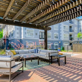 Access to resident-only features a brick patio with tables and chairs