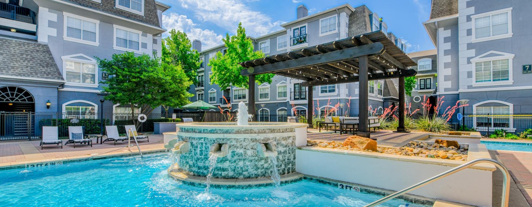 a pool in a courtyard with buildings around it
