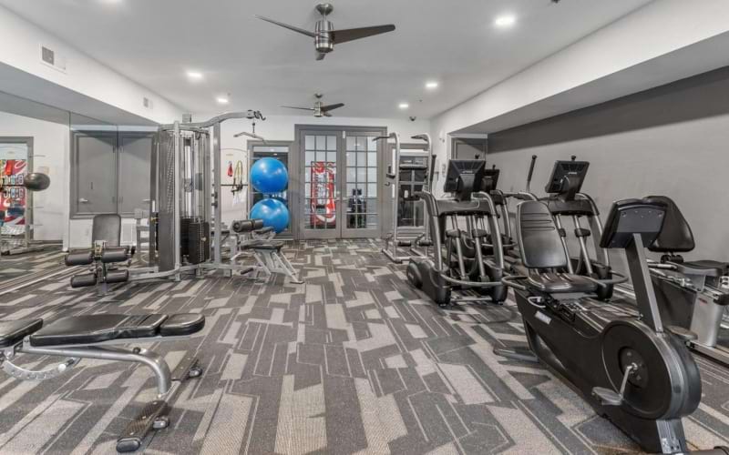 an exercise room with cardio machines
