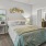 a bedroom with a bed and a fan
